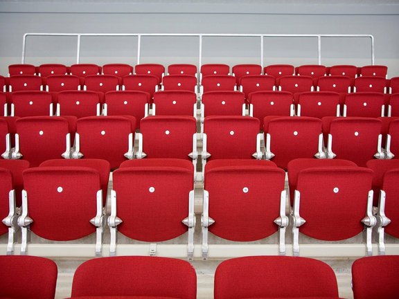 Several rows of comfortable red business seats in the PSD BANK DOME